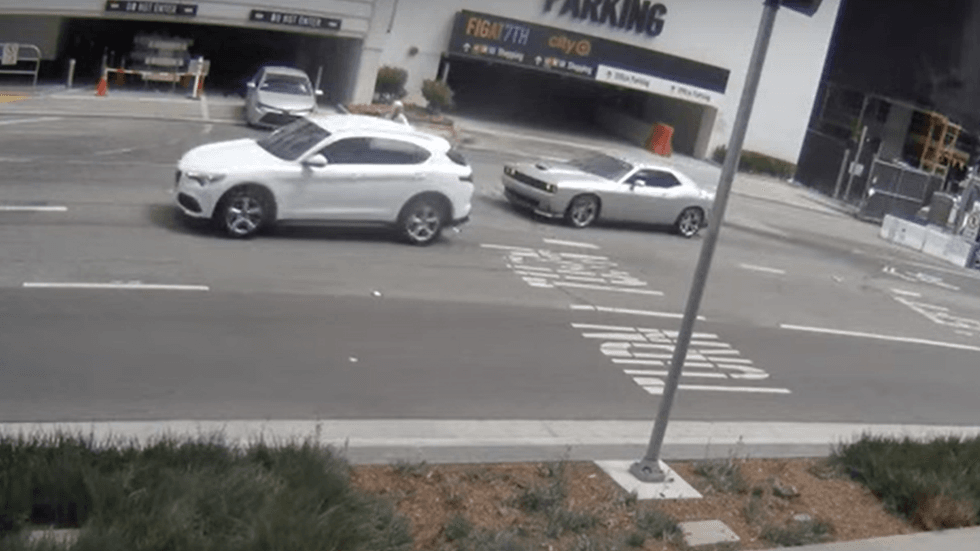 Investigators with the Los Angeles Police Department are seeking the drivers of a silver Dodge Challenger that was spotted hitting a woman on 8th Street on April 11, 2022 in Los Angeles. The victim told police she was targeted by the men as she left a jewelry store.