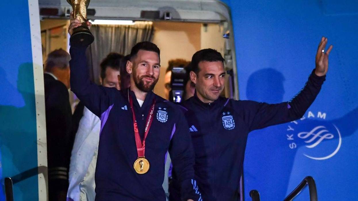 ionel Messi of Argentina (L) and Lionel Scaloni (R) holds the FIFA World Cup during the arrival of the Argentina men's national football team after winning the FIFA World Cup Qatar 2022 on December 20, 2022 in Buenos Aires, Argentina.