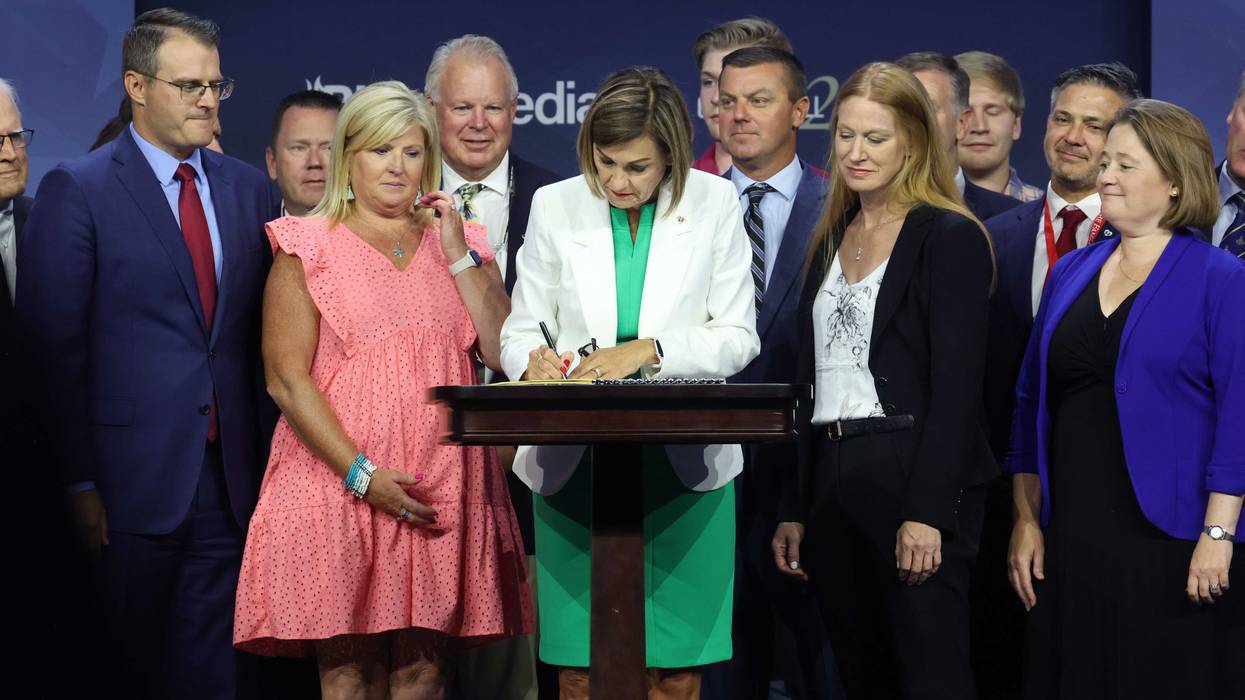 Iowa Governor Kim Reynolds signs into law a bill that will ban most abortions after around six weeks of pregnancy during a visit to the Family Leadership Summit on July 14, 2023 in Des Moines, Iowa.