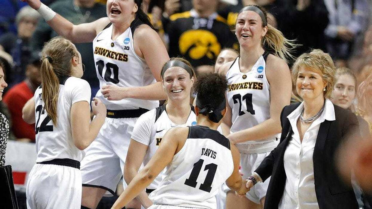 Iowa players including Megan Gustafson (10) and Hannah Stewart (21) celebrates in the closing seconds of the second half of a regional women's college basketball game against North Carolina State in the NCAA Tournament in Greensboro, N.C., Saturday, March