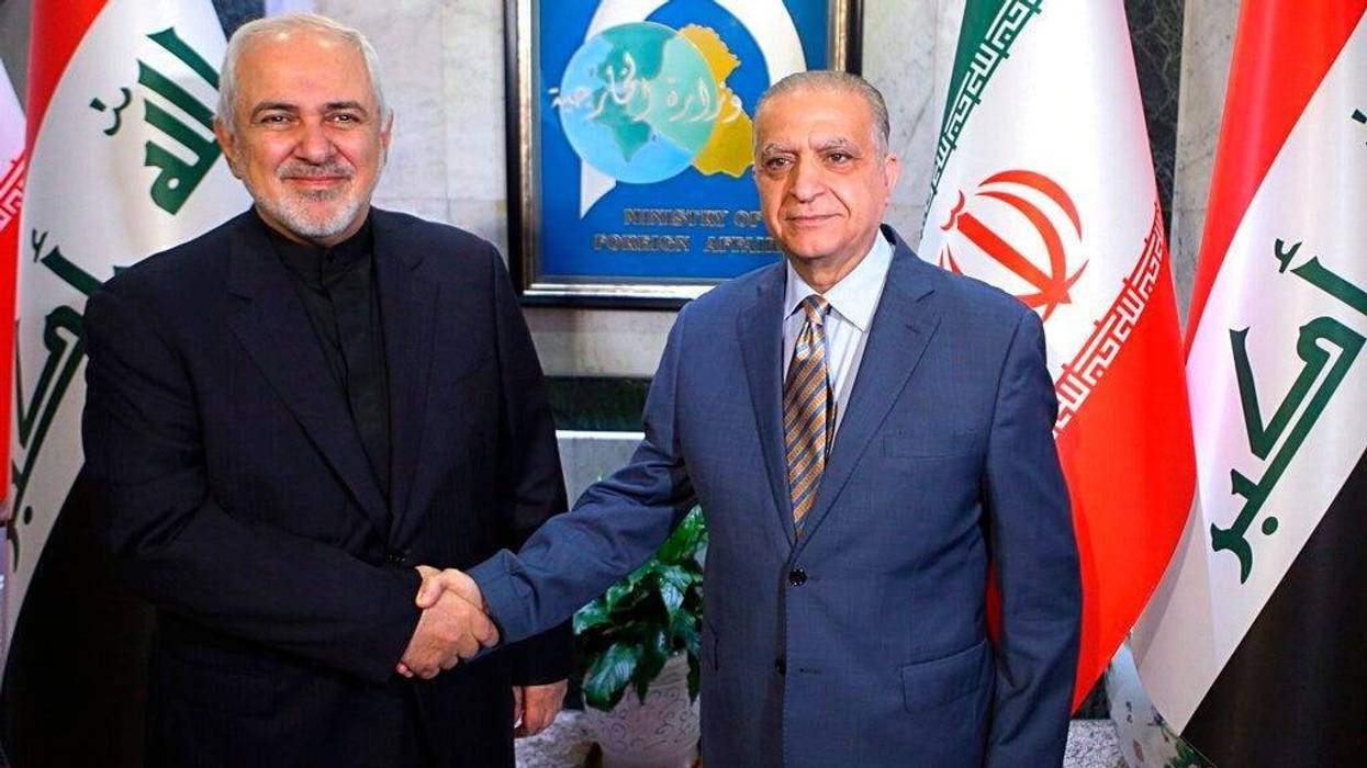 Iraqi Foreign Minister Mohamed Alhakim, right, shakes hands with his visiting Iranian counterpart Mohammad Javad Zarif at the Ministry of Foreign Affairs Building in Baghdad, Iraq, Sunday, May 26, 2019