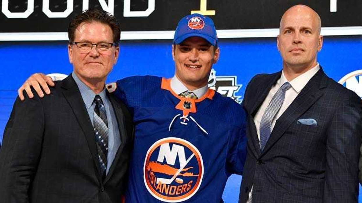 Islanders' first-round draft pick Oliver Wahlstrom poses with with team representatives after being selected as the 11th overall pick.