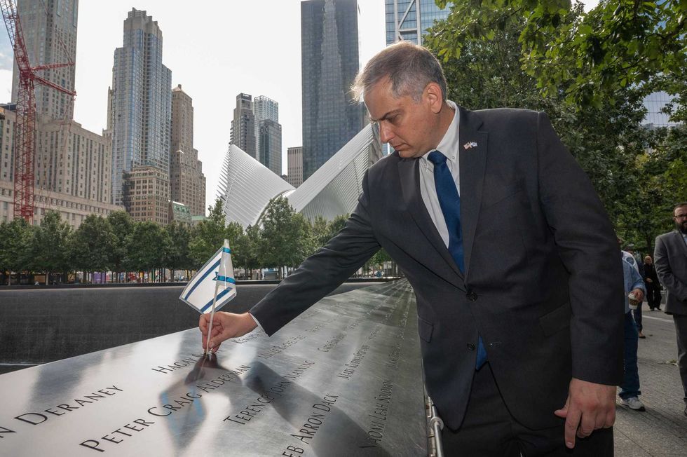 Israel Nitzan, Acting Consul General of Israel in New York places an Israeli flag on Hagay Shefi
