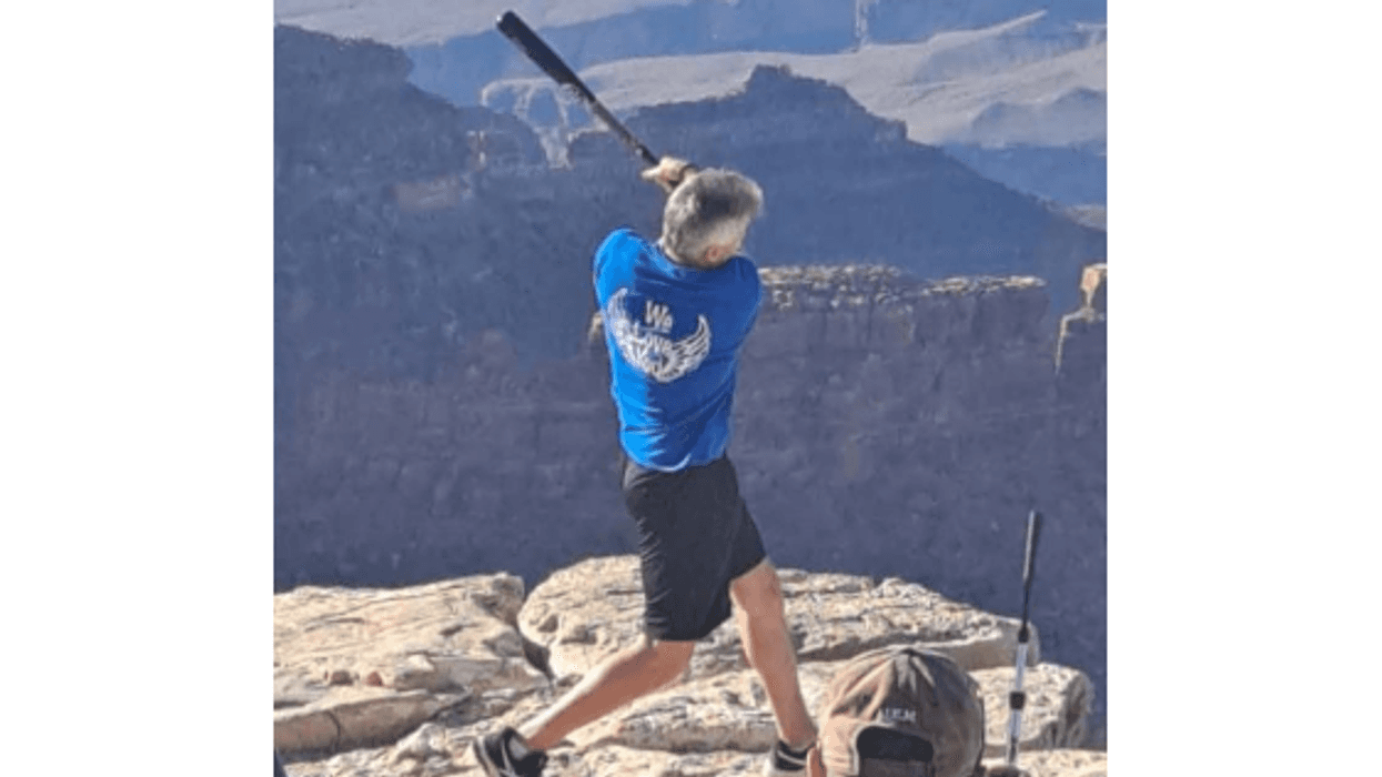 It appeared as if the man was being photographed and was hitting off a tee.