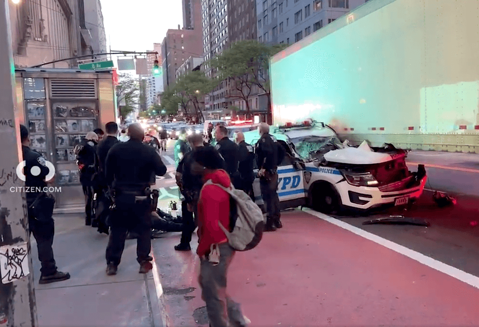 It appears the police cruiser t-boned the trailer of the truck