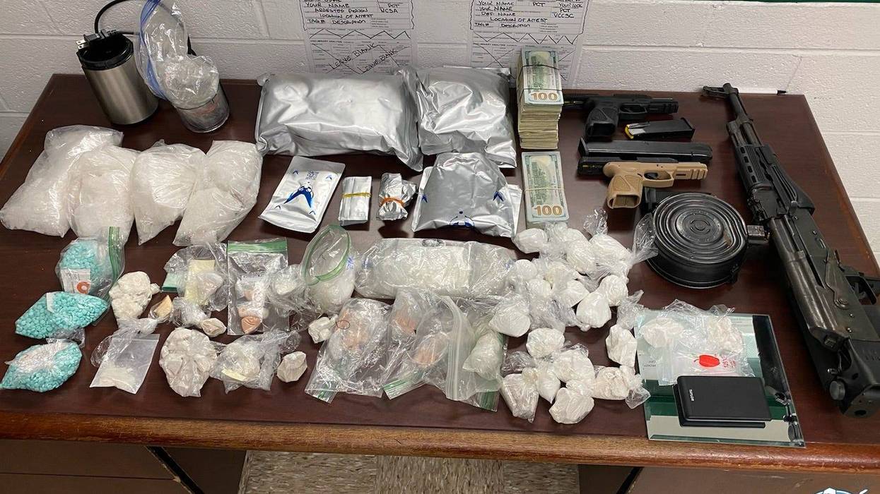 It was an unexpected double win for Detroit Police on Tuesday when they went to arrest a shooting suspect and ended up stumbling across guns and large amounts of drugs in the home.