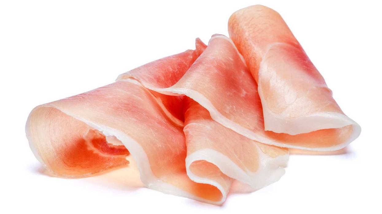 Italian prosciutto crudo or spanish jamon. Raw ham. Isolated on white background.