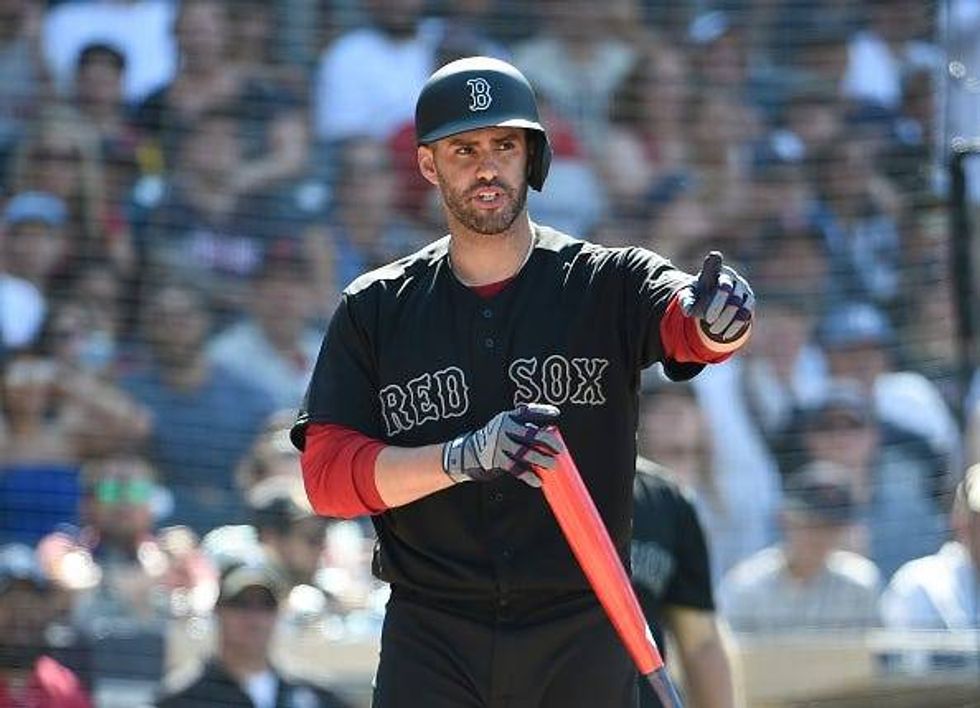J.D. Martinez points to the dugout during a Red Sox game.