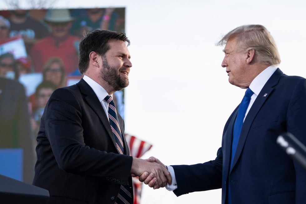 J.D. Vance, a Republican candidate for U.S. Senate in Ohio, shakes hands with former President Donald Trump during a rally hosted by the former president at the Delaware County Fairgrounds on April 23, 2022 in Delaware, Ohio. Last week, Trump announced his endorsement of J.D. Vance in the Ohio Republican Senate primary.