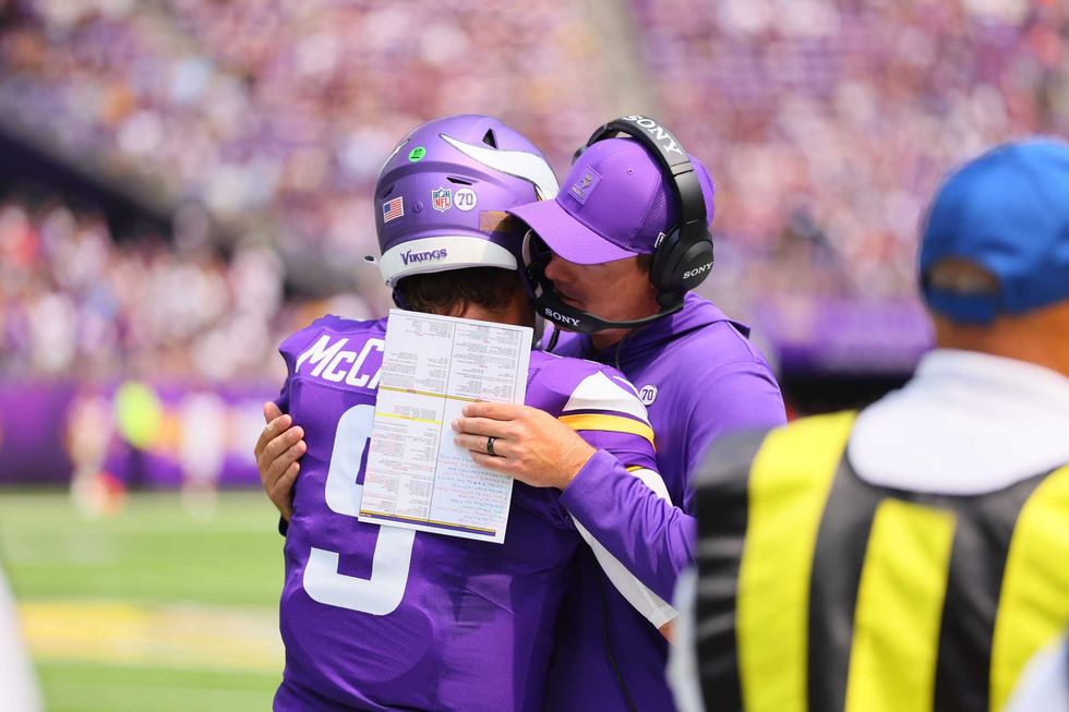 J.J. McCarthy #9 and Head Coach Kevin O