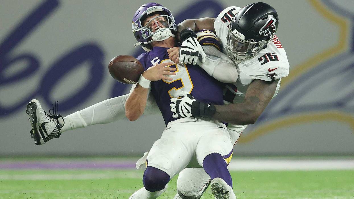 J.J. McCarthy #9 of the Minnesota Vikings fumbles the ball while being sacked by Zach Harrison #96 of the Atlanta Falcons during the fourth quarter in the game at U.S. Bank Stadium on September 14, 2025 in Minneapolis, Minnesota.