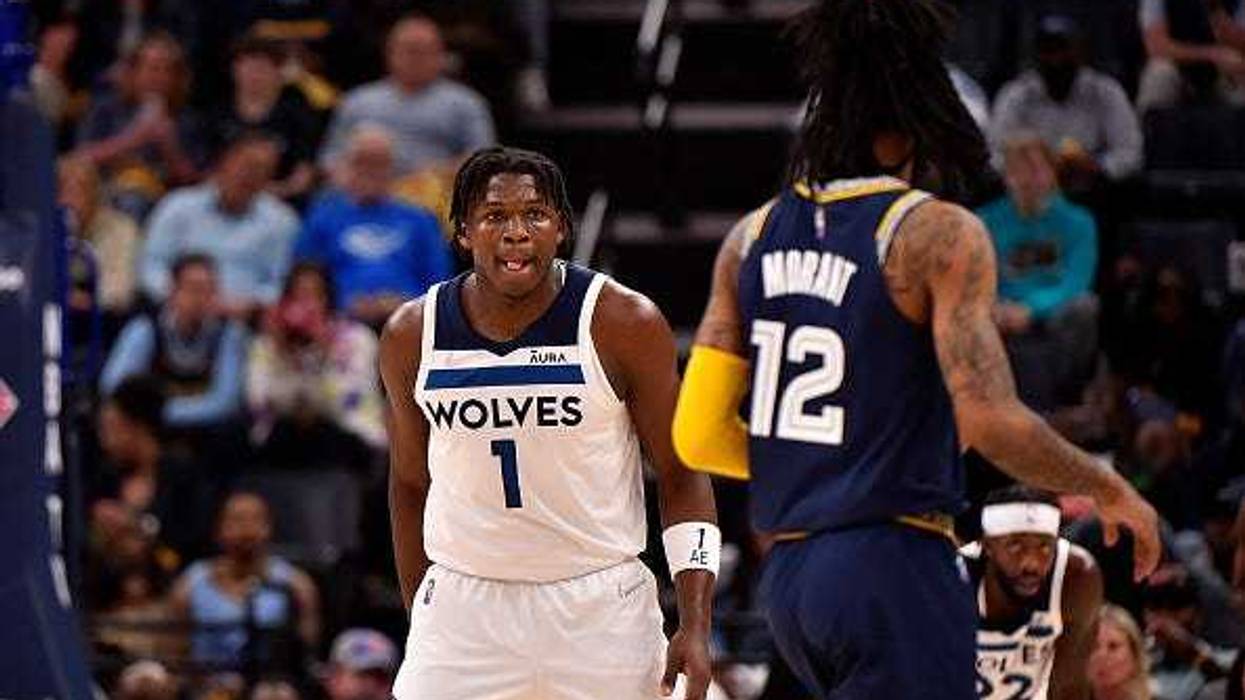 Ja Morant #12 of the Memphis Grizzlies handles the ball against Anthony Edwards #1 of the Minnesota Timberwolves during Game Two of the Western Conference First Round at FedExForum on April 19, 2022 in Memphis, Tennessee.