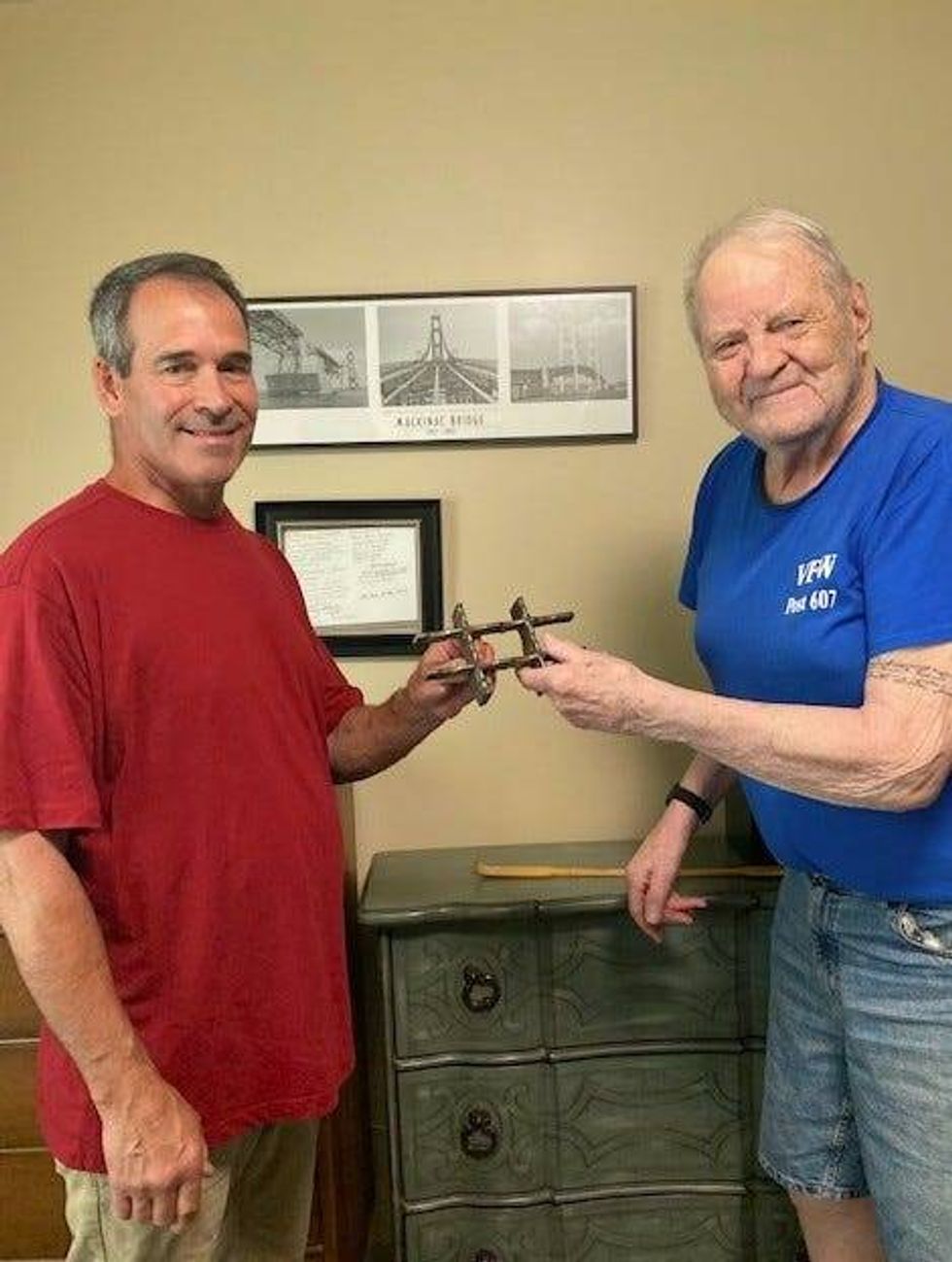 Jack R. Thompson, right, who worked on the Mackinac Bridge in 1956, receives a piece of the bridge