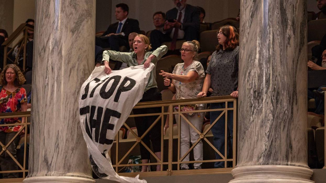Jaeda Roth and other protestors from Abortion Action Missouri unfurl “Stop the Ban” banners as the Missouri Senate passes a proposed constitutional amendment to ban abortion.