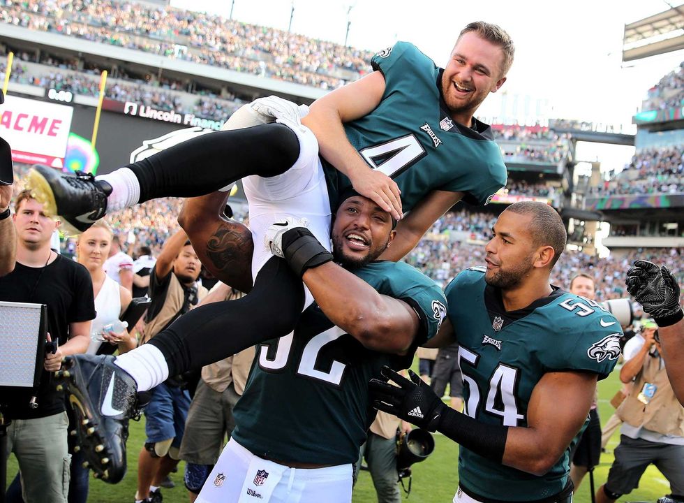 Jake Elliott of the Philadelphia Eagles is picked up by teammates Najee Goode and Kamu Grugier-Hill after Elliott kicked the game-winning field goal with one second left in the game against the New York Giants on Sept. 24, 2017 at Lincoln Financial Field in Philadelphia, Pennsylvania. Elliott kicked the 61-yard field goal to defeat the New York Giants 27-24.