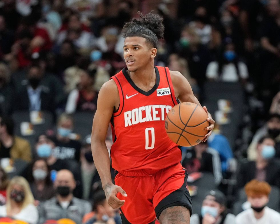 Jalen Green dribbles up court during a Rockets preseason game.