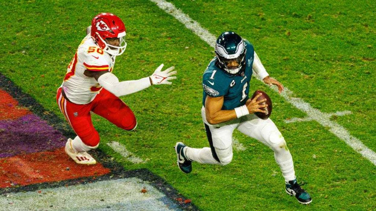 Jalen Hurts and member of Kansas City Chiefs playing football