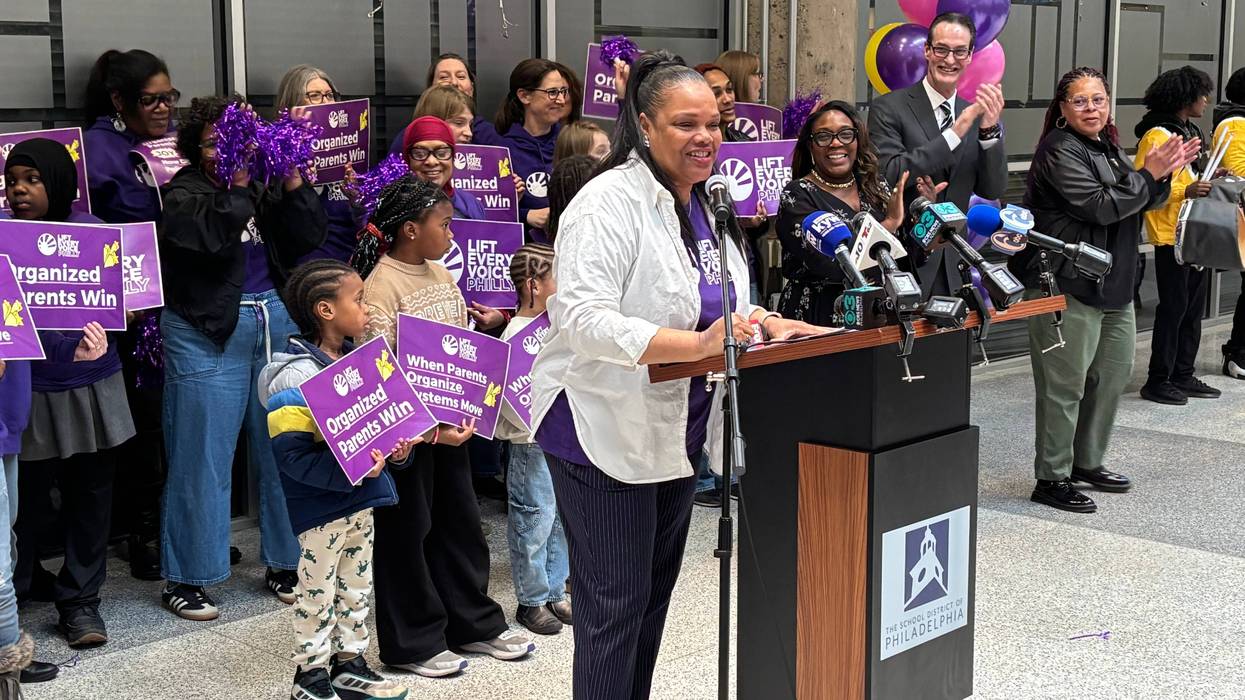 Jamila Carter stands at a podium, saying how Philadelphia teachers can no longer withhold recess or bathroom breaks as discipline