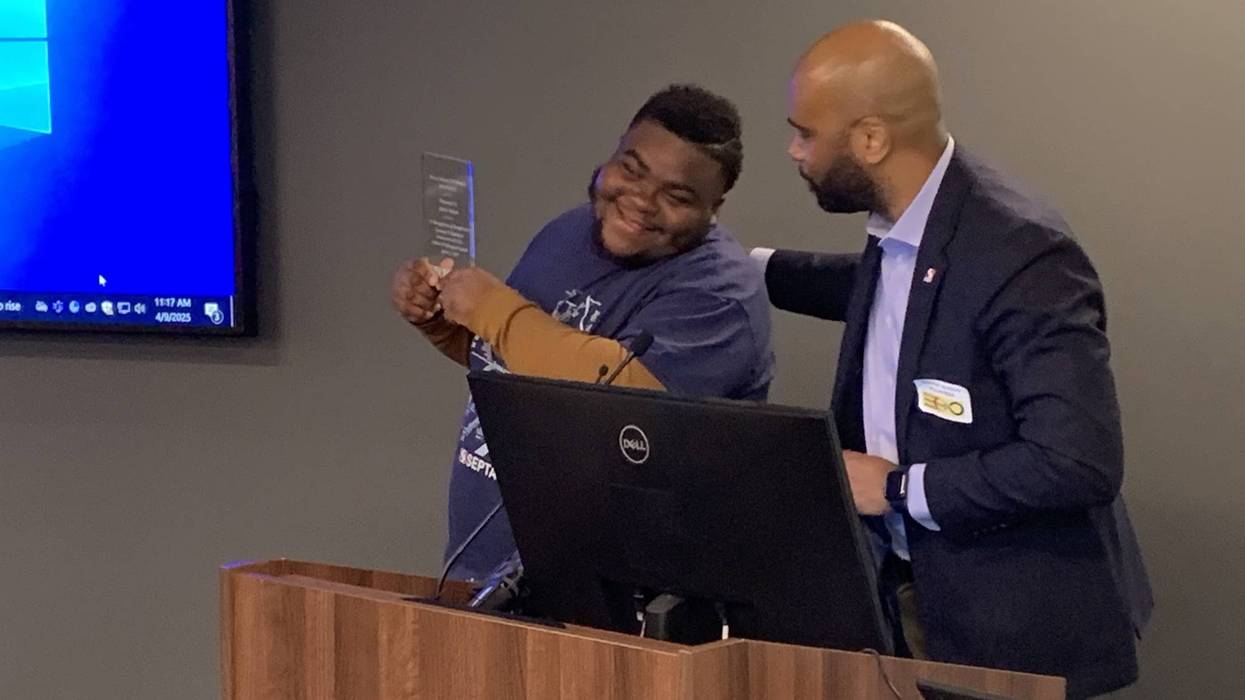 Jamir Nelson (left) is honored by Kenyon Benson of SEPTA's Culture and Belonging Council for his actions last month in defending a bus driver from rowdy passengers.