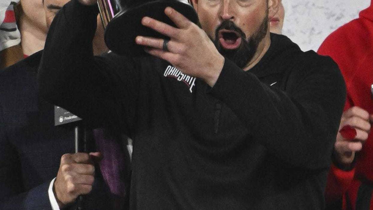 Jan 1, 2025; Pasadena, CA, USA; Ohio State Buckeyes head coach Ryan Day holds up the Roae Bowl game championship trophy after defeating the Oregon Ducks at Rose Bowl Stadium.