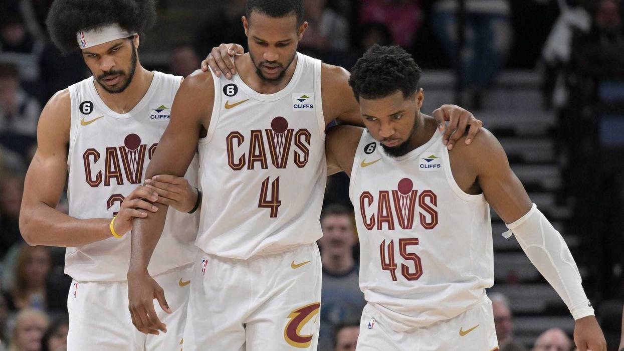 Jan 14, 2023; Minneapolis, Minnesota, USA; Cleveland Cavaliers forward Evan Mobley (4) is helped off the court by guard Donovan Mitchell (45) and center Jarrett Allen (31) during the second quarter at Target Center.