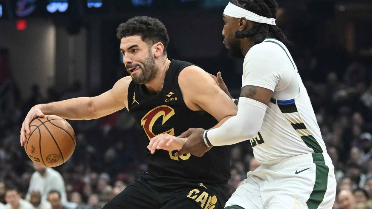 Jan 17, 2024; Cleveland, Ohio, USA; Cleveland Cavaliers forward Georges Niang (20) drives to the basket against Milwaukee Bucks forward Jae Crowder (99) during the first half at Rocket Mortgage FieldHouse.