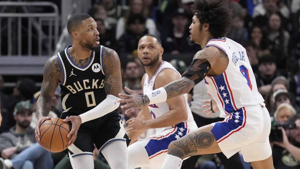 Jan 19, 2025; Milwaukee, Wisconsin, USA; Milwaukee Bucks guard Damian Lillard (0) looks for an outlet pass against Philadelphia 76ers guard Kelly Oubre Jr. (9) in the second half at Fiserv Forum. Mandatory Credit: Michael McLoone-Imagn Images