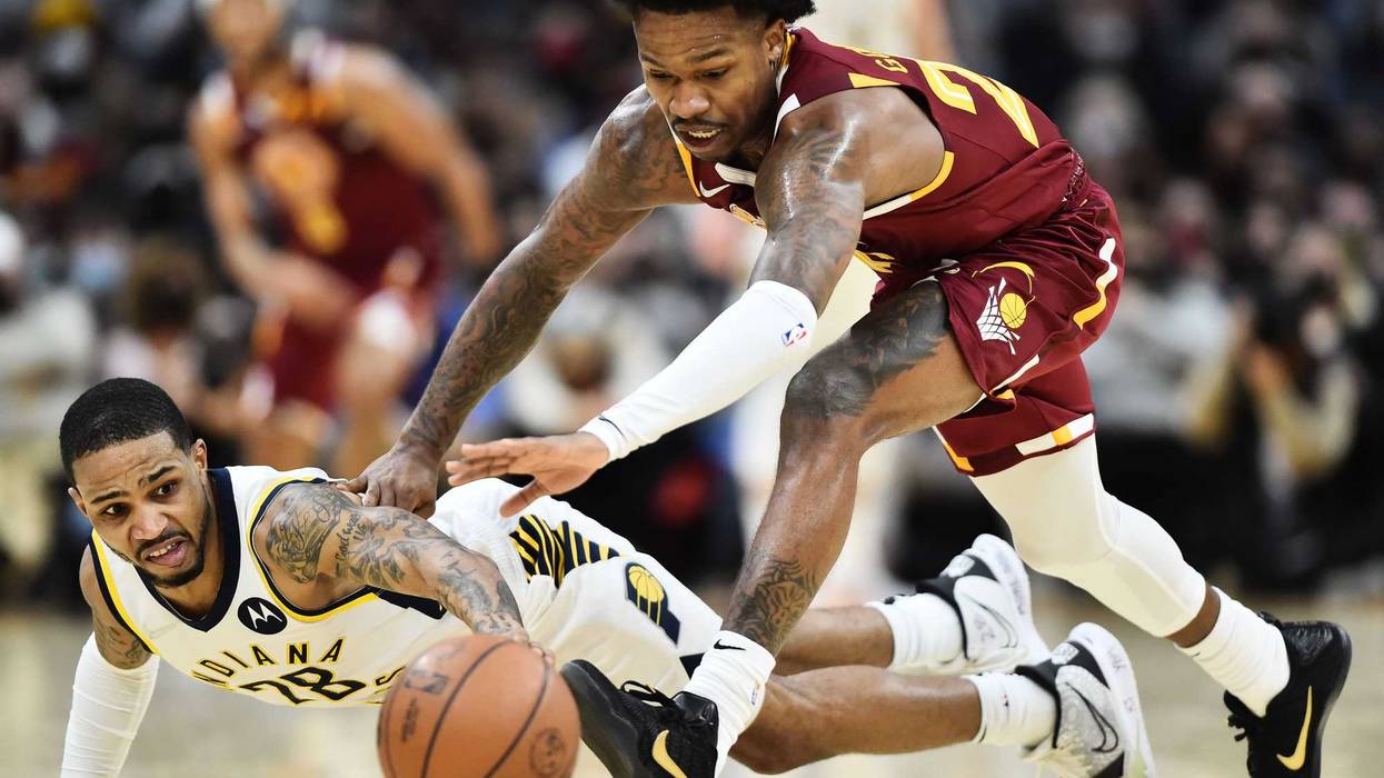 Jan 2, 2022; Cleveland, Ohio, USA; Cleveland Cavaliers guard Brandon Goodwin (26) and Indiana Pacers guard Keifer Sykes (28) battle for a loose ball during the second half at Rocket Mortgage FieldHouse.