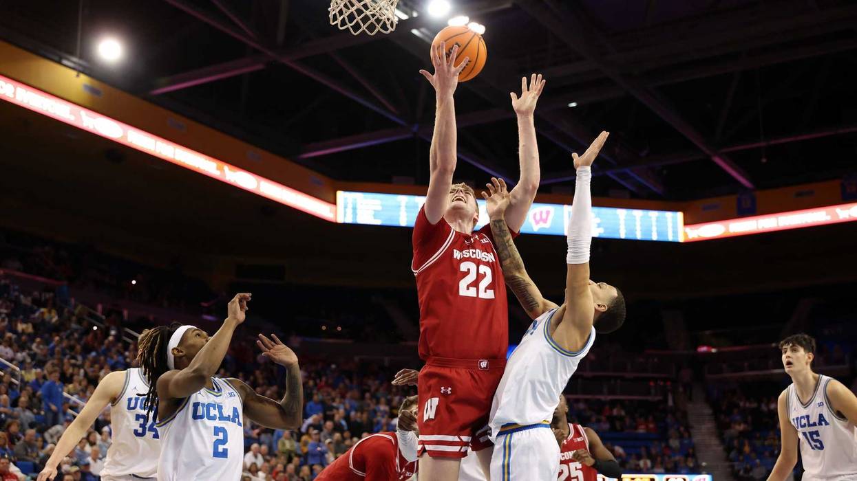 Jan 21, 2025; Los Angeles, California, USA; Wisconsin Badgers forward Steven Crowl (22) going up for a rebound against UCLA Bruins guard Kobe Johnson (0) during the second half at Pauley Pavilion presented by Wescom. Mandatory Credit: Kiyoshi Mio-Imagn Images
