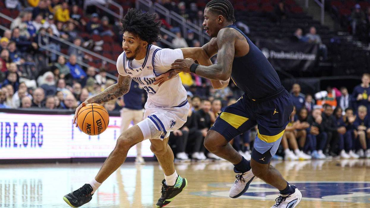 Jan 21, 2025; Newark, New Jersey, USA; Seton Hall Pirates guard Isaiah Coleman (21) goes to the basket as Marquette Golden Eagles guard Kam Jones (1) defends during the second half at Prudential Center. Mandatory Credit: Vincent Carchietta-Imagn Images