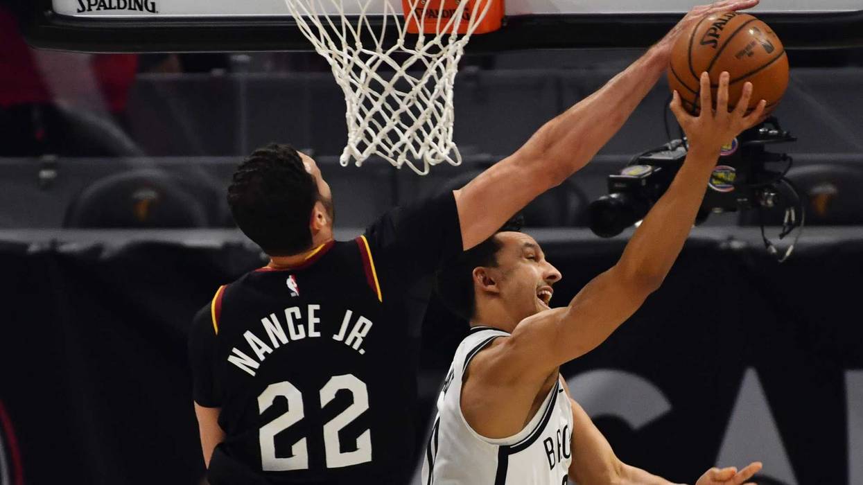 Jan 22, 2021; Cleveland, Ohio, USA; Cleveland Cavaliers forward Larry Nance Jr. (22) blocks the shot of Brooklyn Nets guard Landry Shamet (20) during the first quarter at Rocket Mortgage FieldHouse.