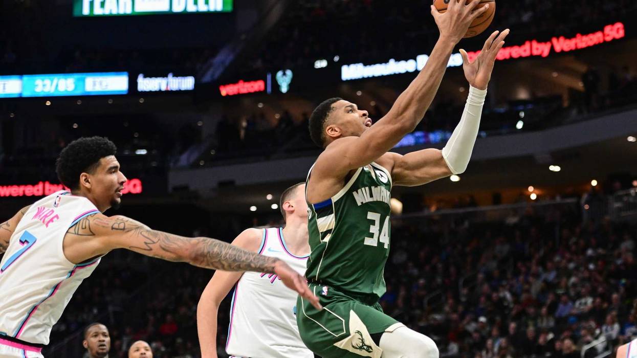 Jan 23, 2025; Milwaukee, Wisconsin, USA; Milwaukee Bucks forward Giannis Antetokounmpo (34) takes a shot against Miami Heat center Kel'el Ware (7) in the fourth quarter at Fiserv Forum. Mandatory Credit: Benny Sieu-Imagn Images