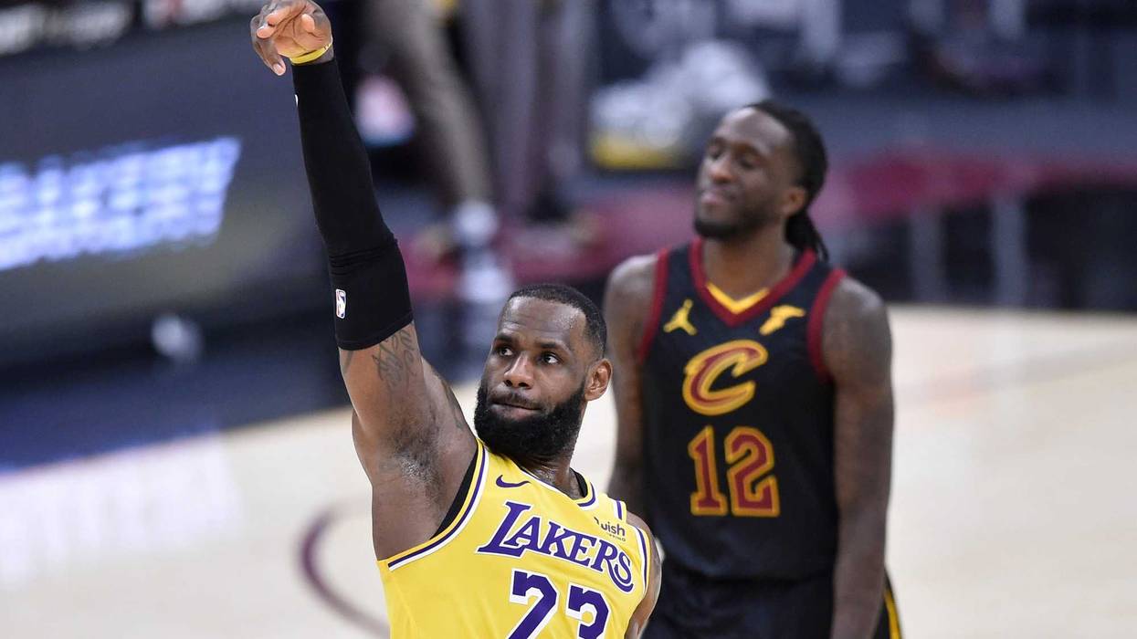 Jan 25, 2021; Cleveland, Ohio, USA; Cleveland Cavaliers forward Taurean Prince (12) reacts as Los Angeles Lakers forward LeBron James (23) makes a three-point basket in the fourth quarter at Rocket Mortgage FieldHouse.