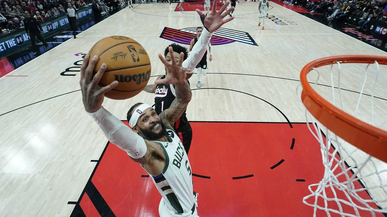 Jan 28, 2025; Portland, Oregon, USA; Milwaukee Bucks shooting guard Gary Trent Jr. (5) goes up for a dunk against Portland Trail Blazers shooting guard Anfernee Simons (1) during the second half at Moda Center. Mandatory Credit: Soobum Im-Imagn Images