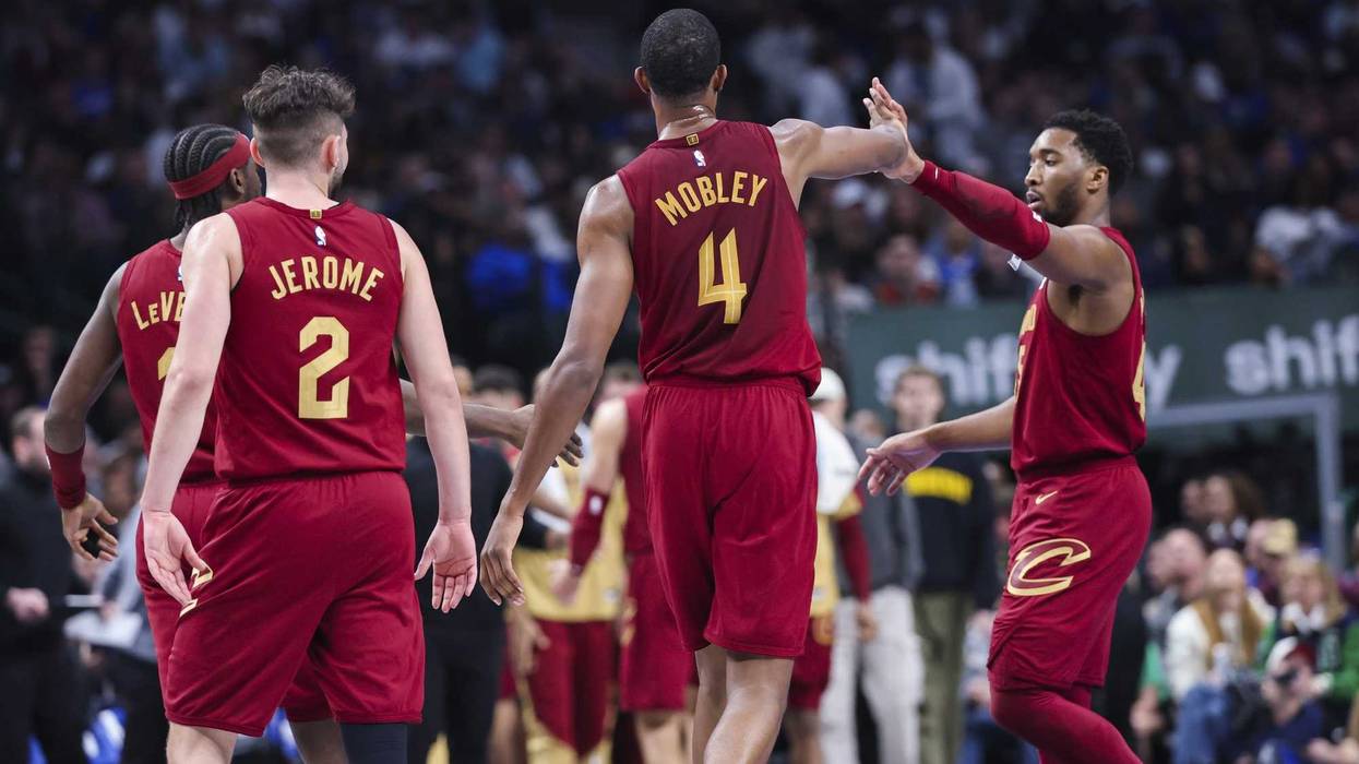 Jan 3, 2025; Dallas, Texas, USA; Cleveland Cavaliers forward Evan Mobley (4) celebrates with Cleveland Cavaliers guard Donovan Mitchell (45) during the first half against the Dallas Mavericks at American Airlines Center.