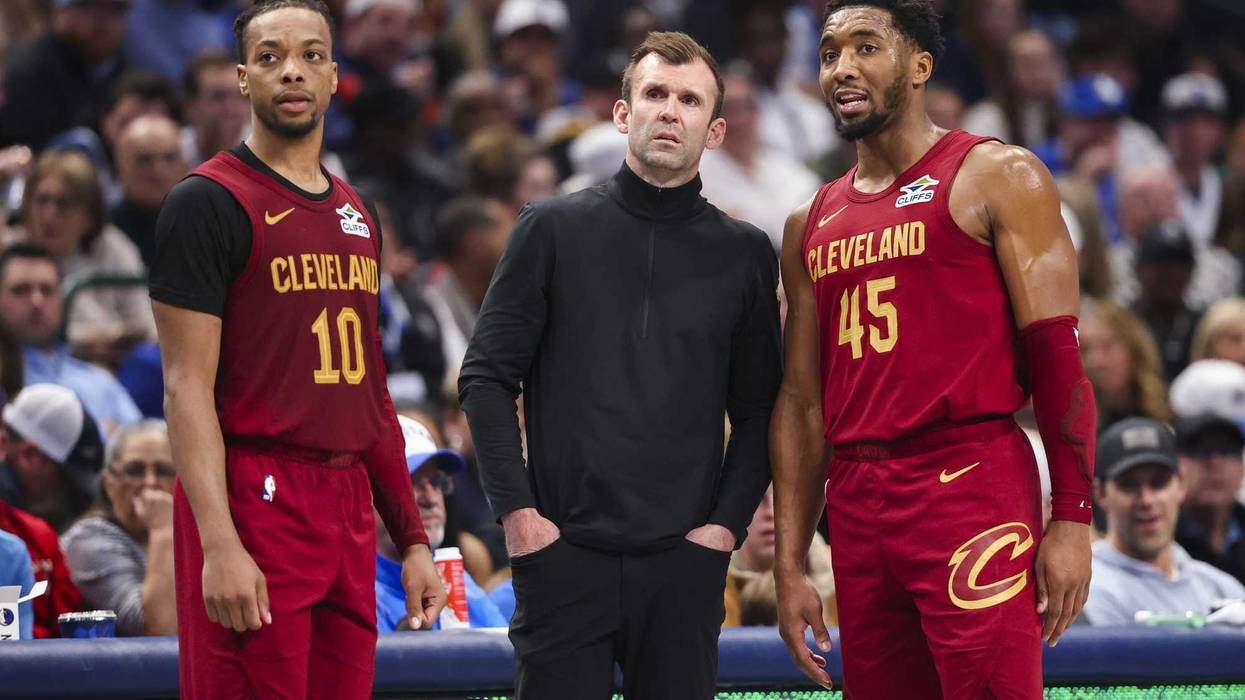 Jan 3, 2025; Dallas, Texas, USA; Cleveland Cavaliers head coach Kenny Atkinson speaks with Cleveland Cavaliers guard Darius Garland (10) and Cleveland Cavaliers guard Donovan Mitchell (45) during the first half against the Dallas Mavericks at American Airlines Center.