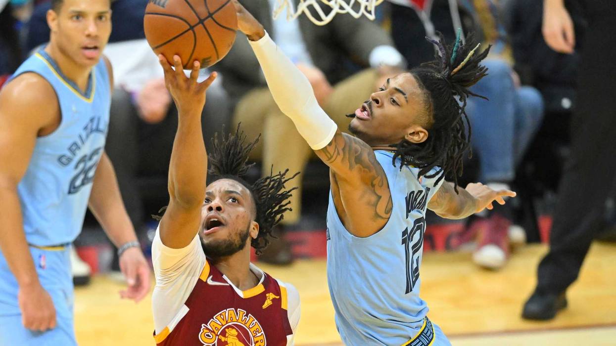 Jan 4, 2022; Cleveland, Ohio, USA; Memphis Grizzlies guard Ja Morant (12) blocks a shot by Cleveland Cavaliers guard Darius Garland (10) in the second quarter at Rocket Mortgage FieldHouse.
