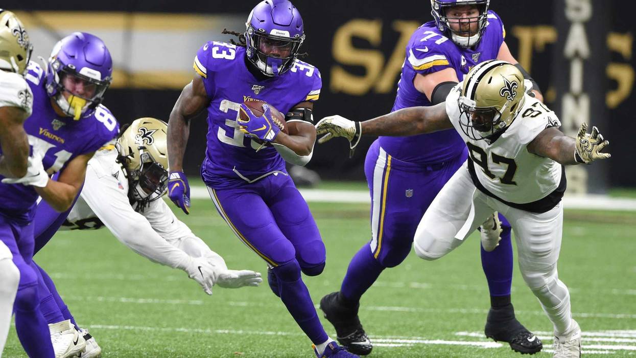 Jan 5, 2020; New Orleans, Louisiana, USA; Minnesota Vikings running back Dalvin Cook (33) runs the ball against New Orleans Saints defensive end Mario Edwards (97) during the first quarter of a NFC Wild Card playoff football game at the Mercedes-Benz Supe