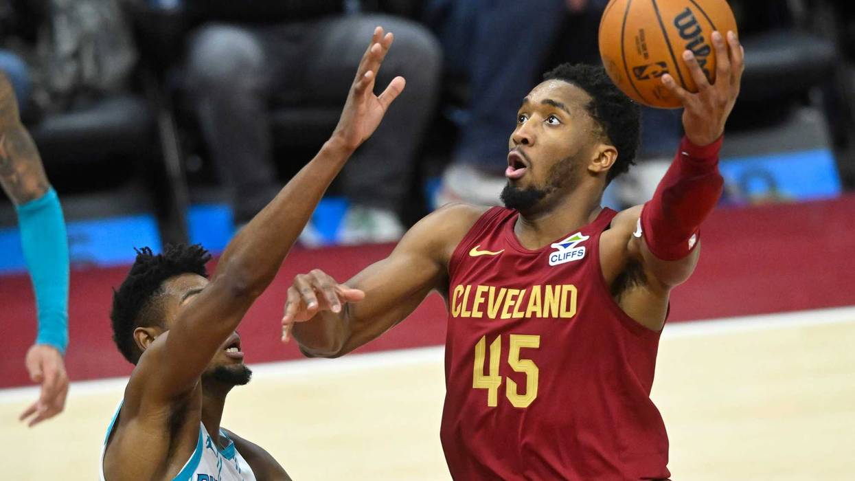 Jan 5, 2025; Cleveland, Ohio, USA; Cleveland Cavaliers guard Donovan Mitchell (45) shoots beside Charlotte Hornets forward Brandon Miller (24) in the fourth quarter at Rocket Mortgage FieldHouse.