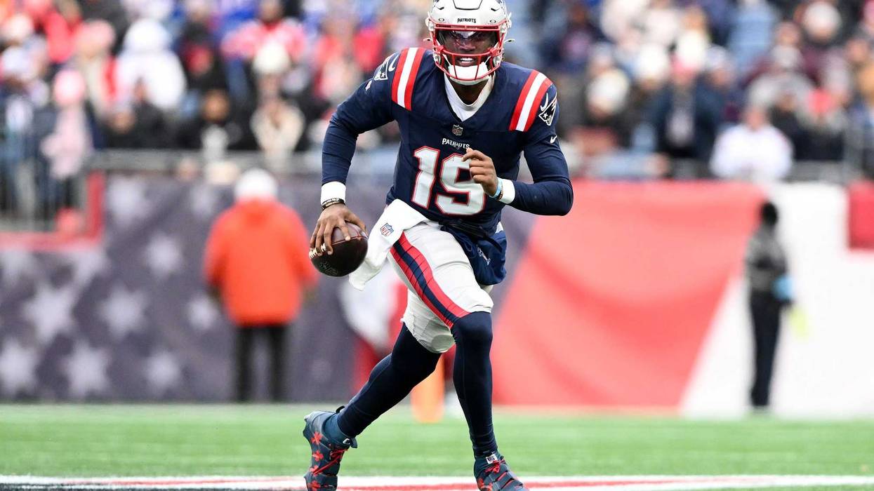 Jan 5, 2025; Foxborough, Massachusetts, USA; New England Patriots quarterback Joe Milton III (19) runs against the Buffalo Bills during the first half at Gillette Stadium.