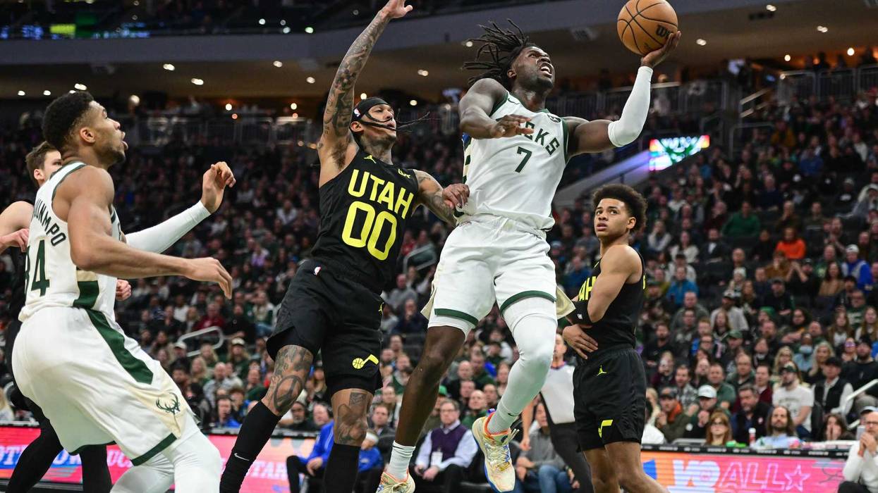 Jan 8, 2024; Milwaukee, Wisconsin, USA; Milwaukee Bucks center Chris Livingston (7) takes a shot against Utah Jazz guard Jordan Clarkson (00) in the fourth quarter at Fiserv Forum. Mandatory Credit: Benny Sieu-Imagn Images