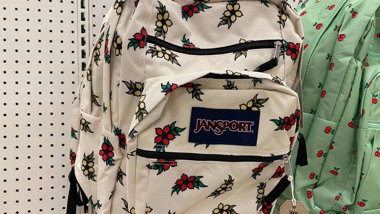JanSport Tattoo Blossom backpack hanging on shelf at Target