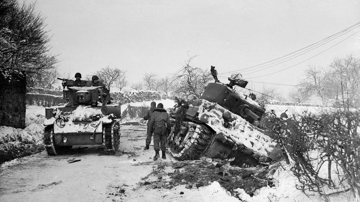 January 1945: Hard going for US tanks at Amonines, Belgium, on the northern flank of the 'battle of the bulge'. A tank on the road passes another being dug out of the snow.