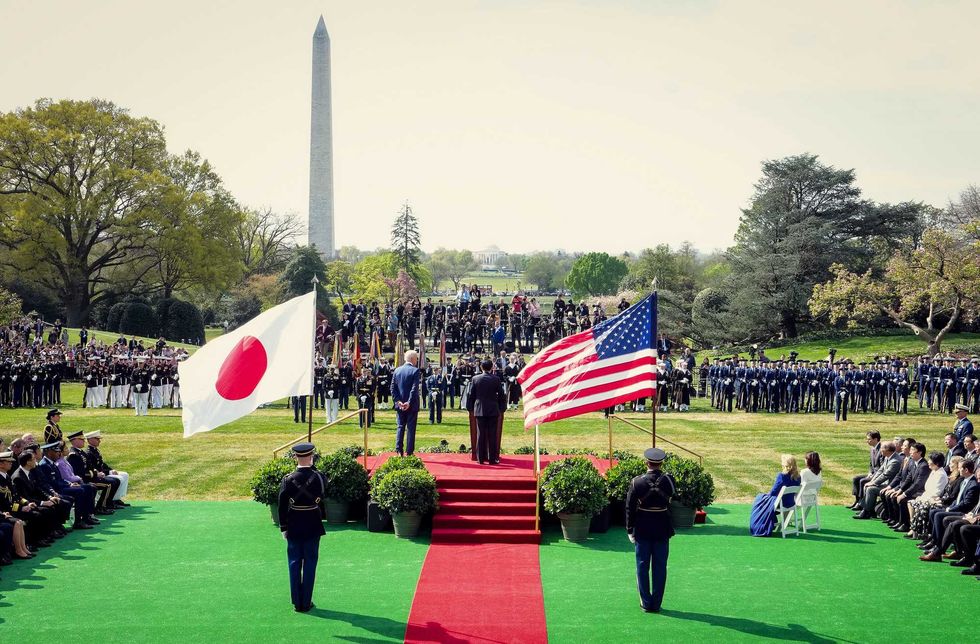 Japanese Prime Minister Fumio Kishida (C) delivers remarks alongside U.S. President Joe Biden during an arrival ceremony at the White House on April 10, 2024