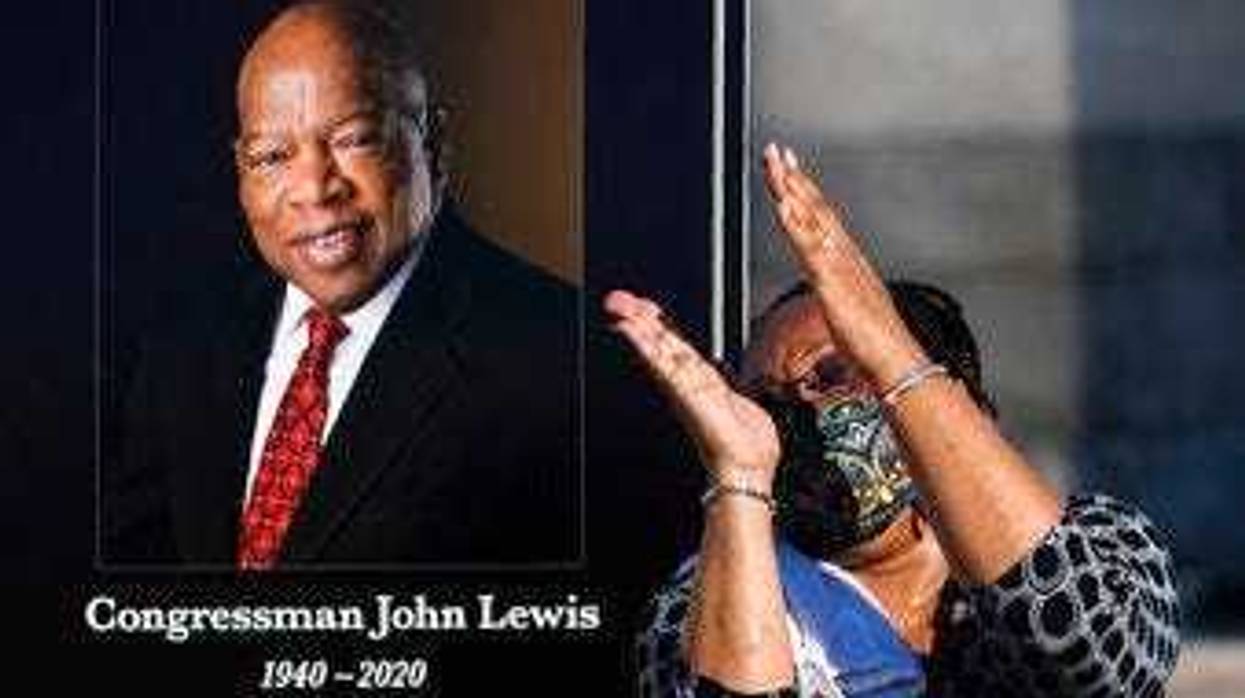 Jaquenette Ferguson from Oxon Hill, Md., gestures as she gets her picture taken beside a portrait of the late Rep. John Lewis, D-Ga., near the East Front Steps of the U.S. the Capitol, Tuesday, July 28, 2020, in Washington. (AP Photo/Manuel Balce Ceneta)