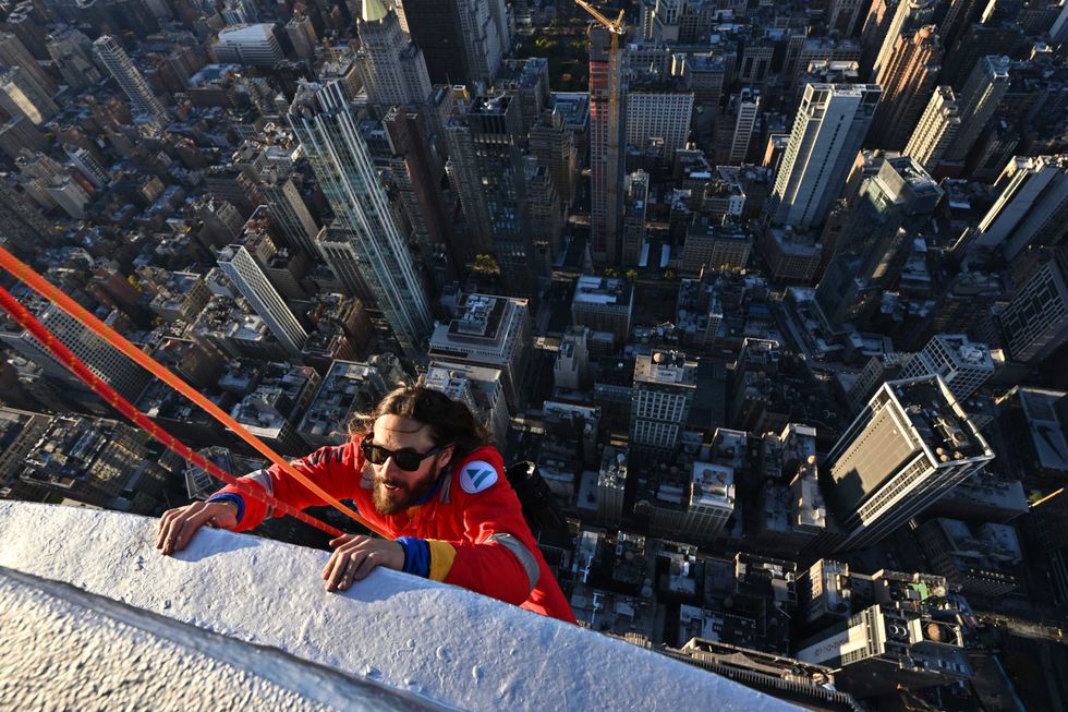Jared Leto hangs on -- while attached to a harness -- to the Empire State Building on Nov. 9, 2023, as part of a promotion for his band Thirty Seconds to Mars