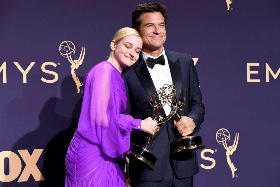 Jason Bateman and Julia Garner pose with awards