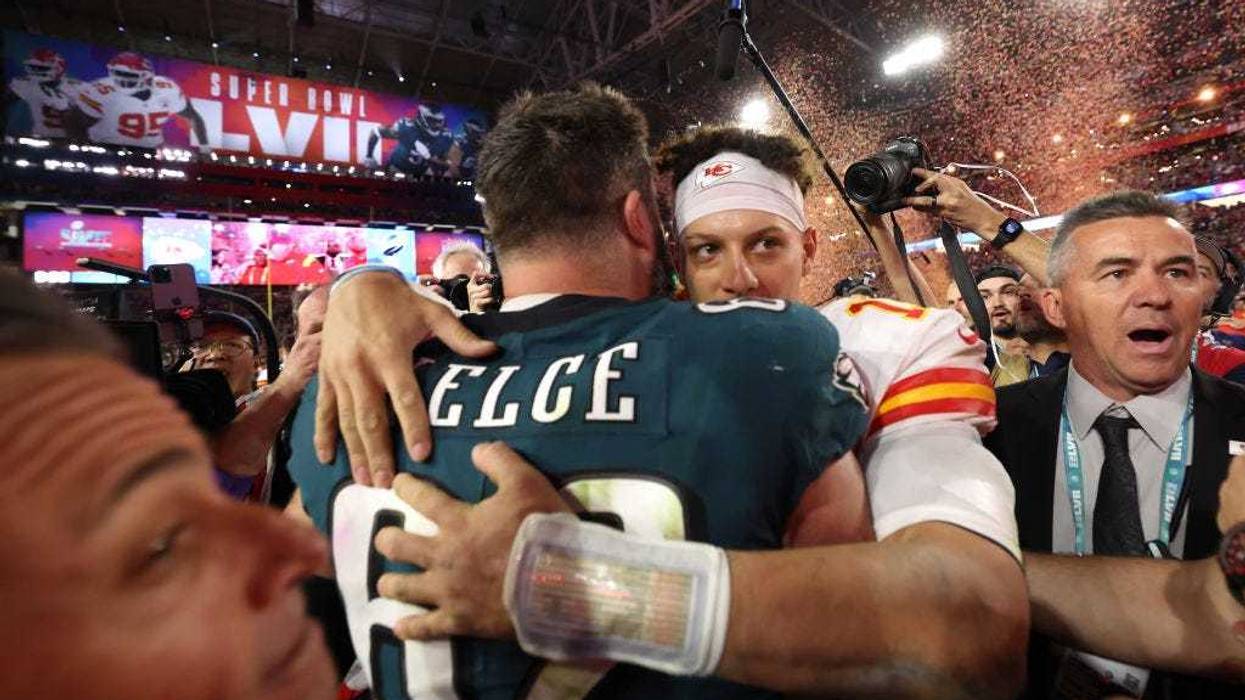 Jason Kelce #62 of the Philadelphia Eagles and Patrick Mahomes #15 of the Kansas City Chiefs embrace on the field after Super Bowl LVII at State Farm Stadium on February 12, 2023 in Glendale, Arizona.