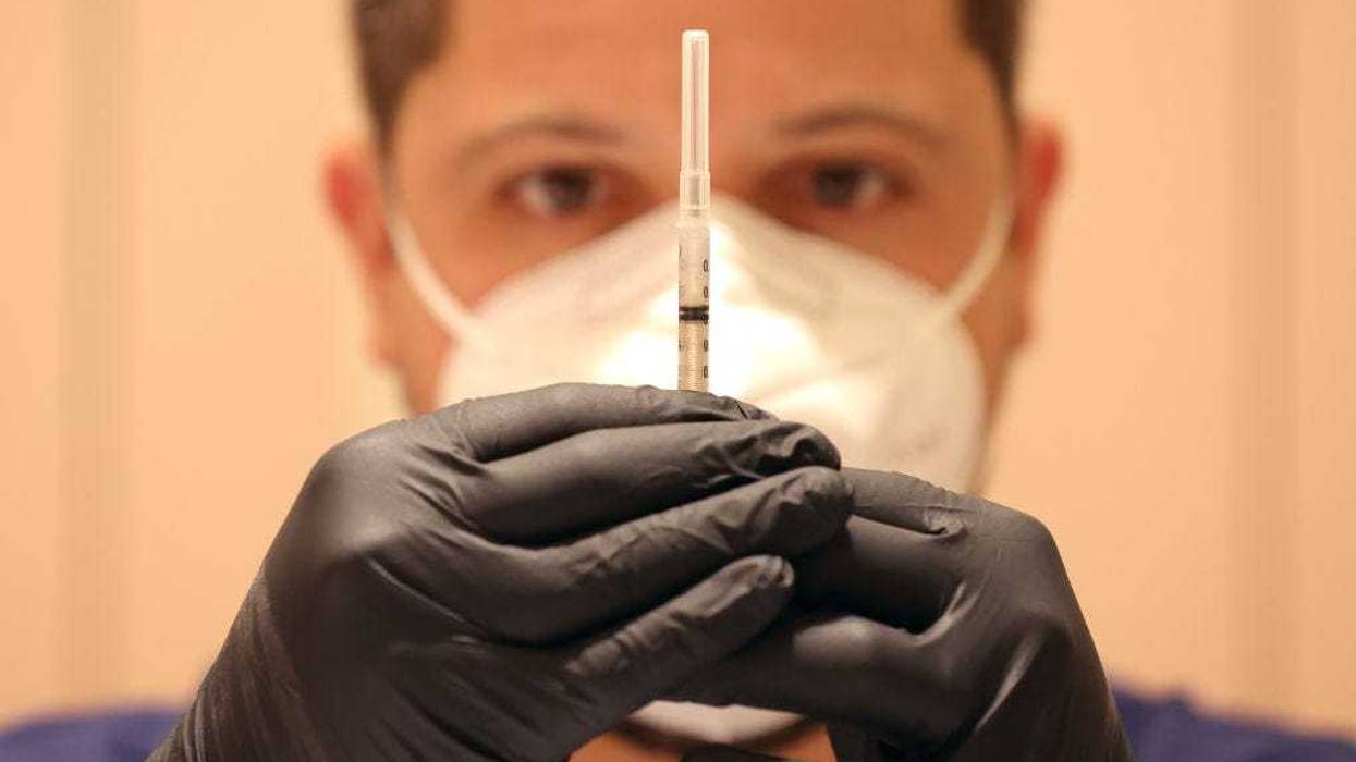 Jatniel Hernandez fills syringes with COID-19 vaccine booster shots at a COVID-19 vaccination clinic on April 06, 2022 in San Rafael, California.
