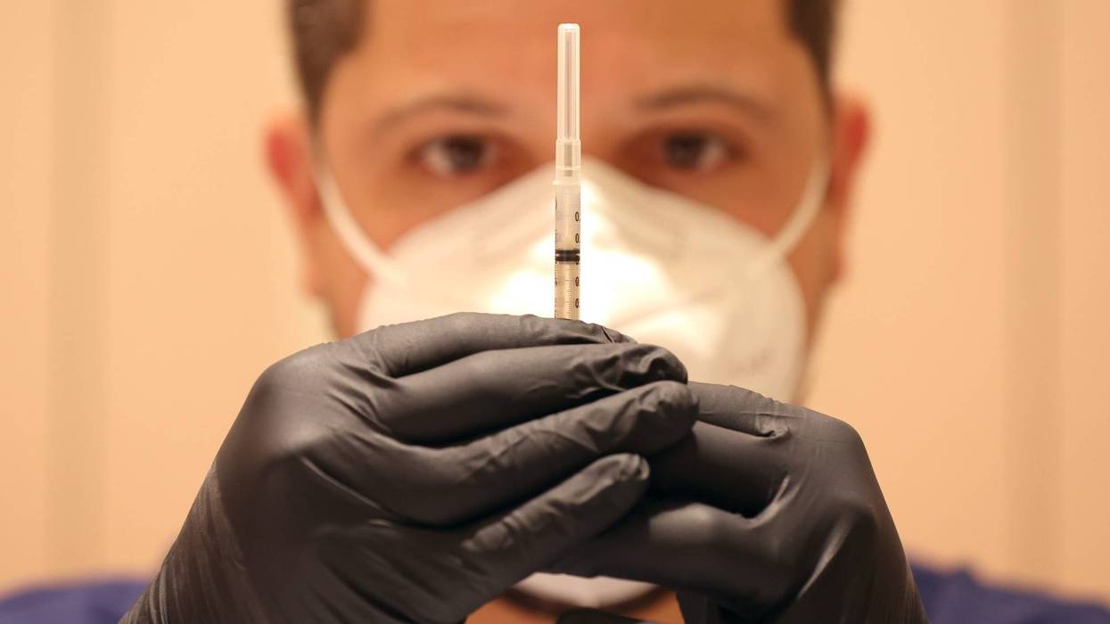 Jatniel Hernandez fills syringes with COID-19 vaccine booster shots at a COVID-19 vaccination clinic on April 06, 2022 in San Rafael, California.